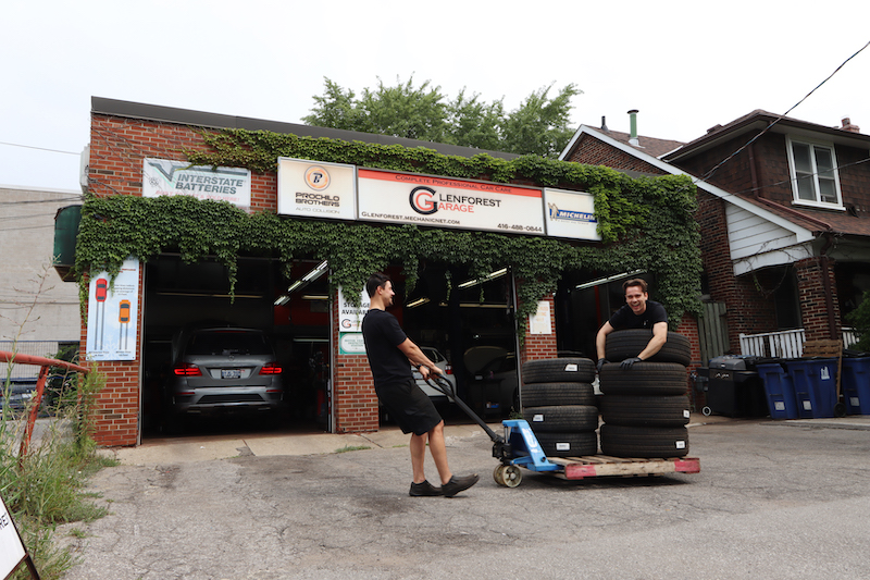 Two tire storage employees pulling tires in Toronto